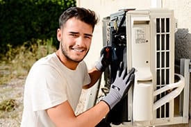 A Broward Technical Colleges student works on an outdoor air conditioning unit in summer classes.